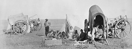 Camp scene of Métis people with carts on the prairie, 1872-1873