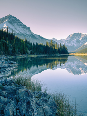 Snow capped mountains reflecting in the lake in Jasper National Park, Canadian Rockies